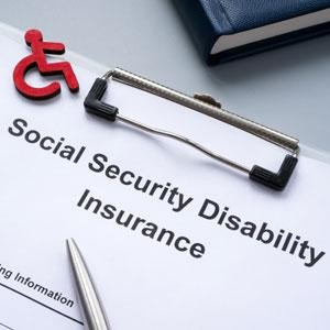 Social Security Disability Insurance form with pen and clipboard.