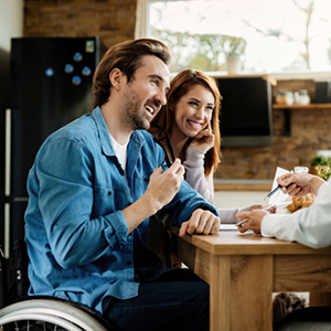 A smiling couple in a kitchen, representing adult SSDI/SSI application.