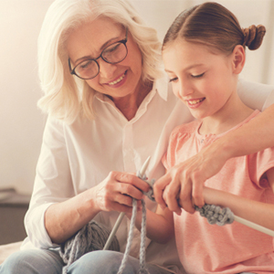 A grandmother and child crafting together to represent SSDI/SSI criteria.