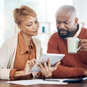 A couple reviewing a tablet for faster Social Security disability decisions.