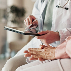 A patient in a clinic discussing a medical condition with a healthcare provider.