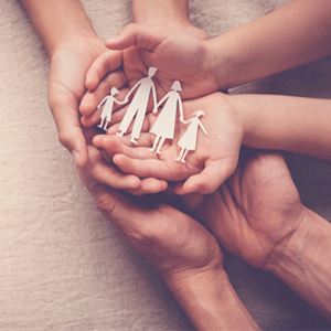 Hands holding paper cutouts of a family, representing SSDI protection.