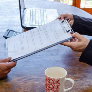 Two people reviewing a medical clipboard to establish credibility in a disability case.
