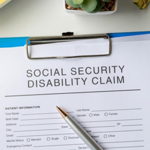 Social Security disability claim form on a desk, representing mental health benefits.