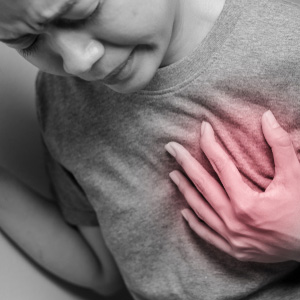 A person clutching their chest in pain, representing congestive heart failure.