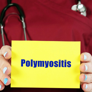 A person holding a bright yellow sign that reads 