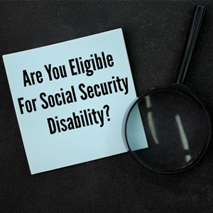 A magnifying glass over a note asking about Social Security disability eligibility.